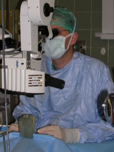 Ophthalmology surgeon observing through a microscope