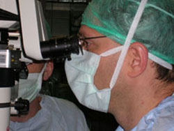 Eye surgeon looking through a surgical microscope